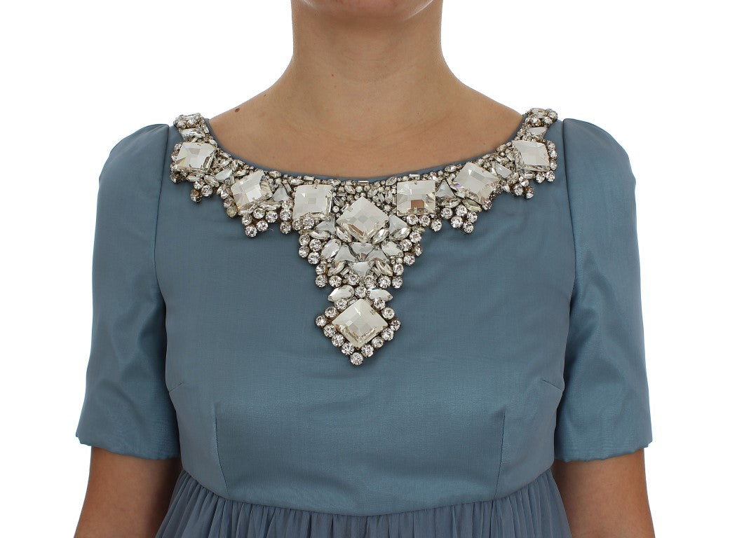 Woman wearing a blue dress with a sparkly neckline