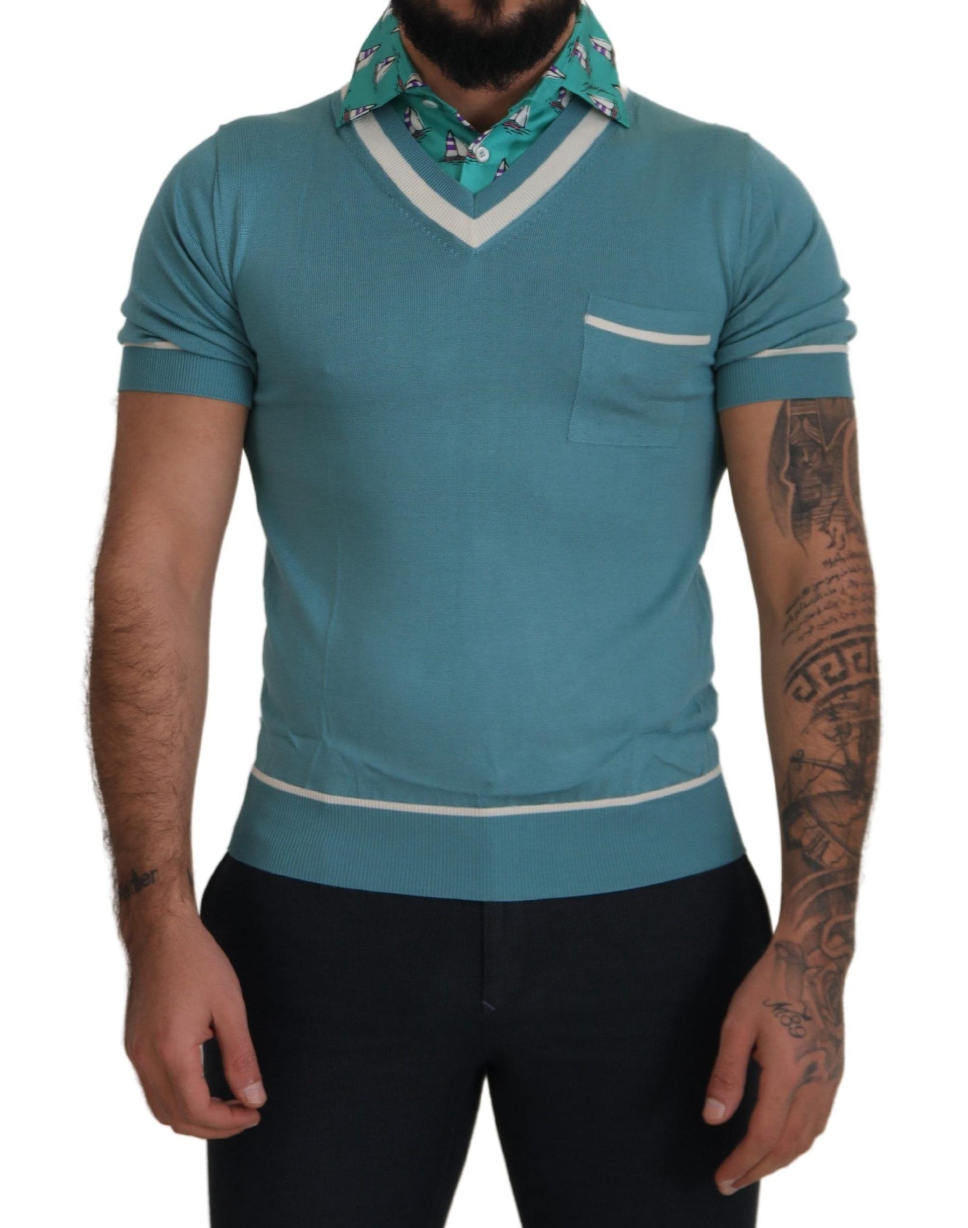Man wearing blue sweater vest with white trim and pocket on left side
