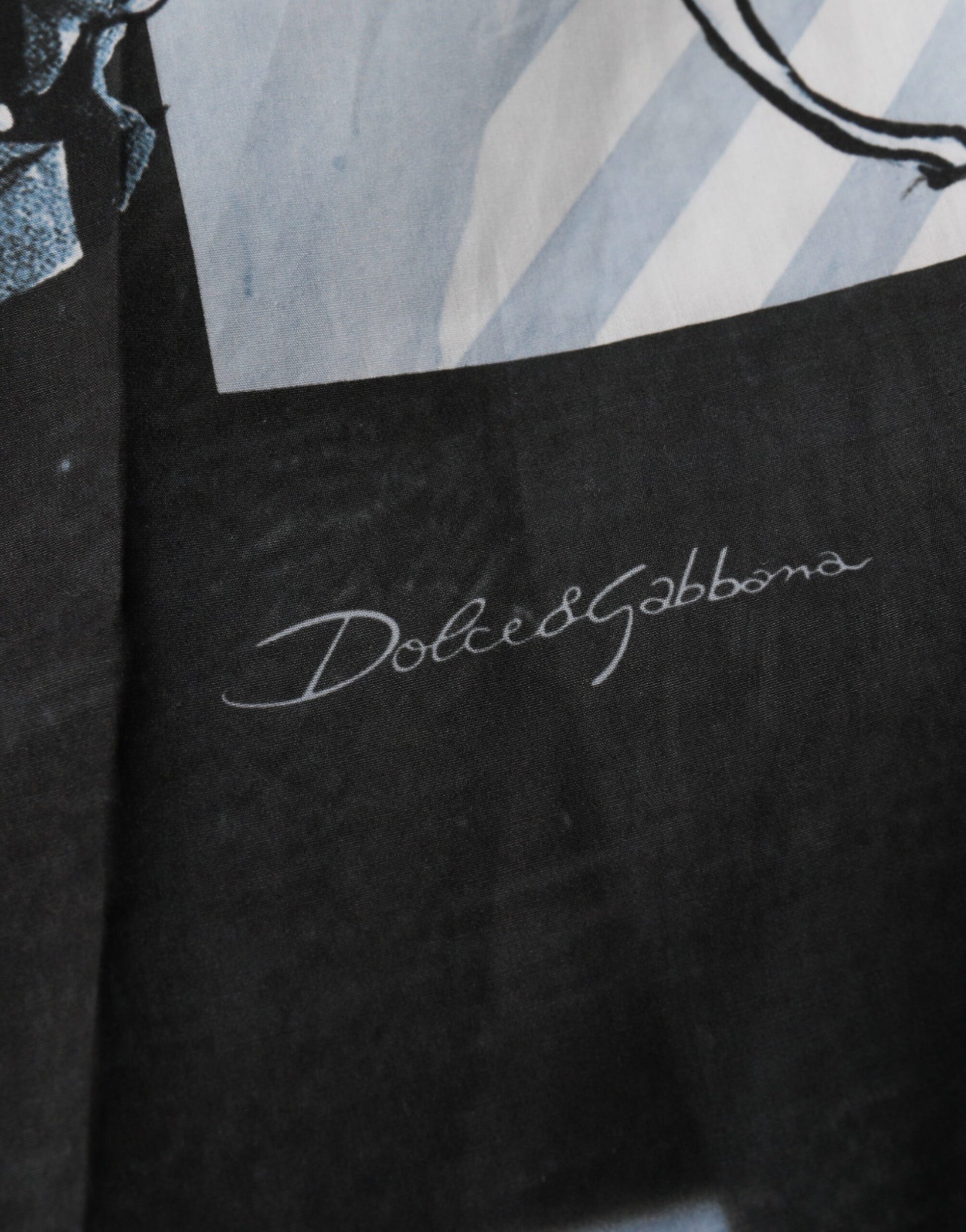 A pair of blue shorts with a statue print, featuring the Dolce & Gabbana logo on the waistband