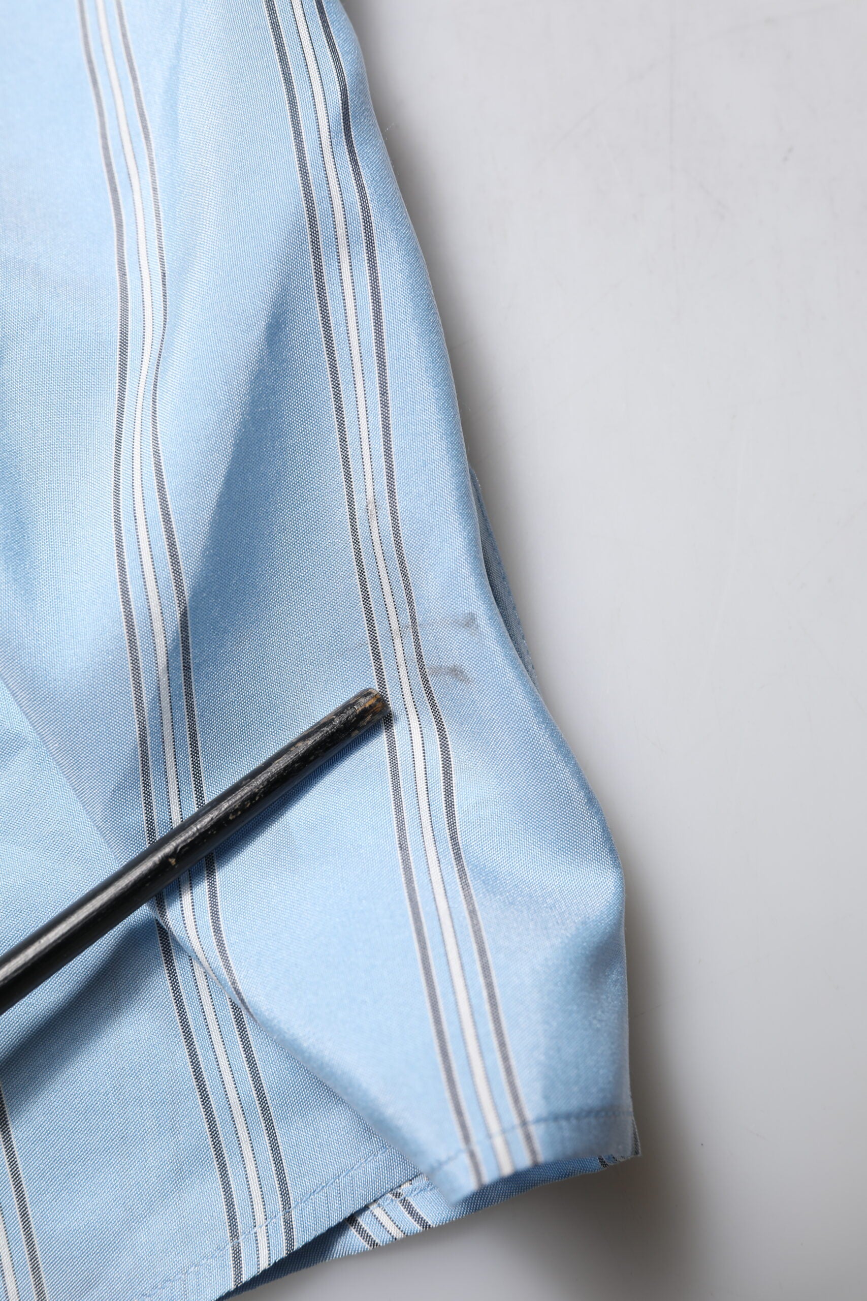 A blue striped dress shirt with long sleeves