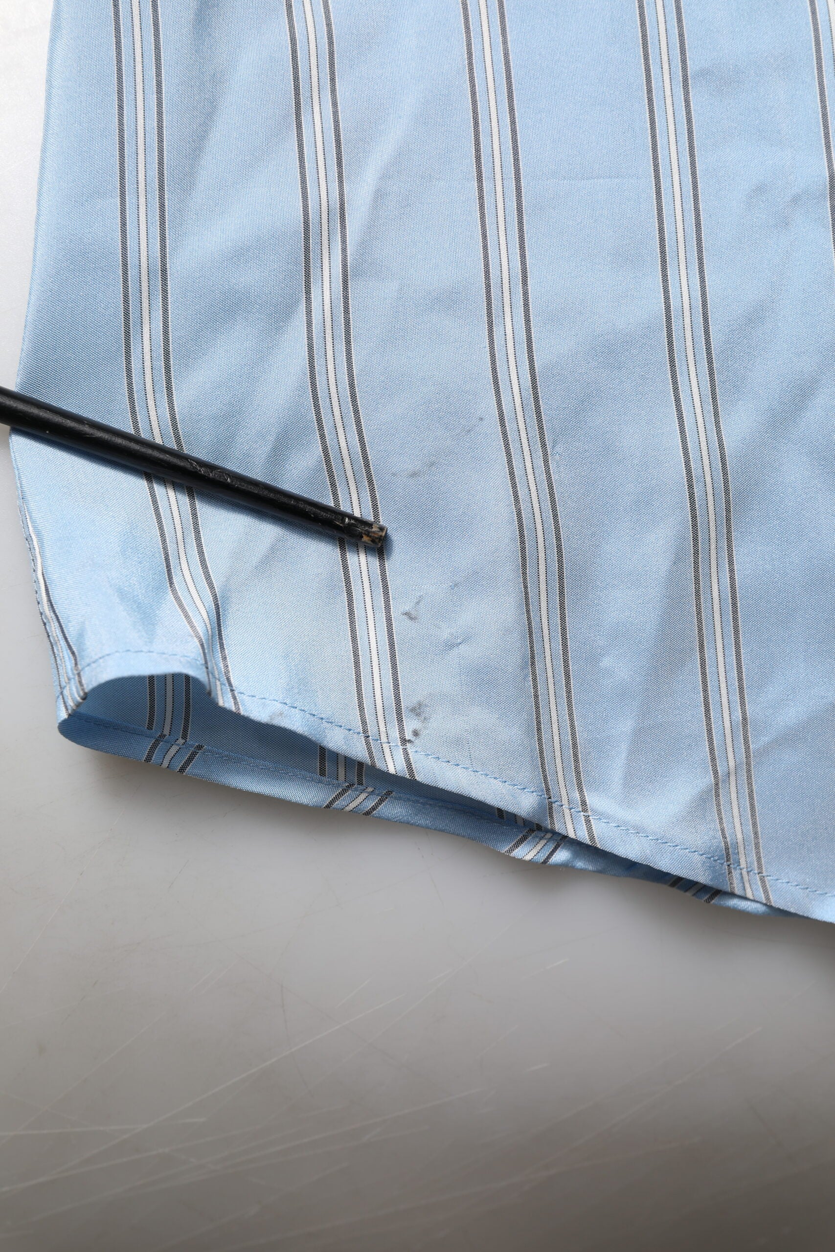 A blue striped dress shirt with long sleeves