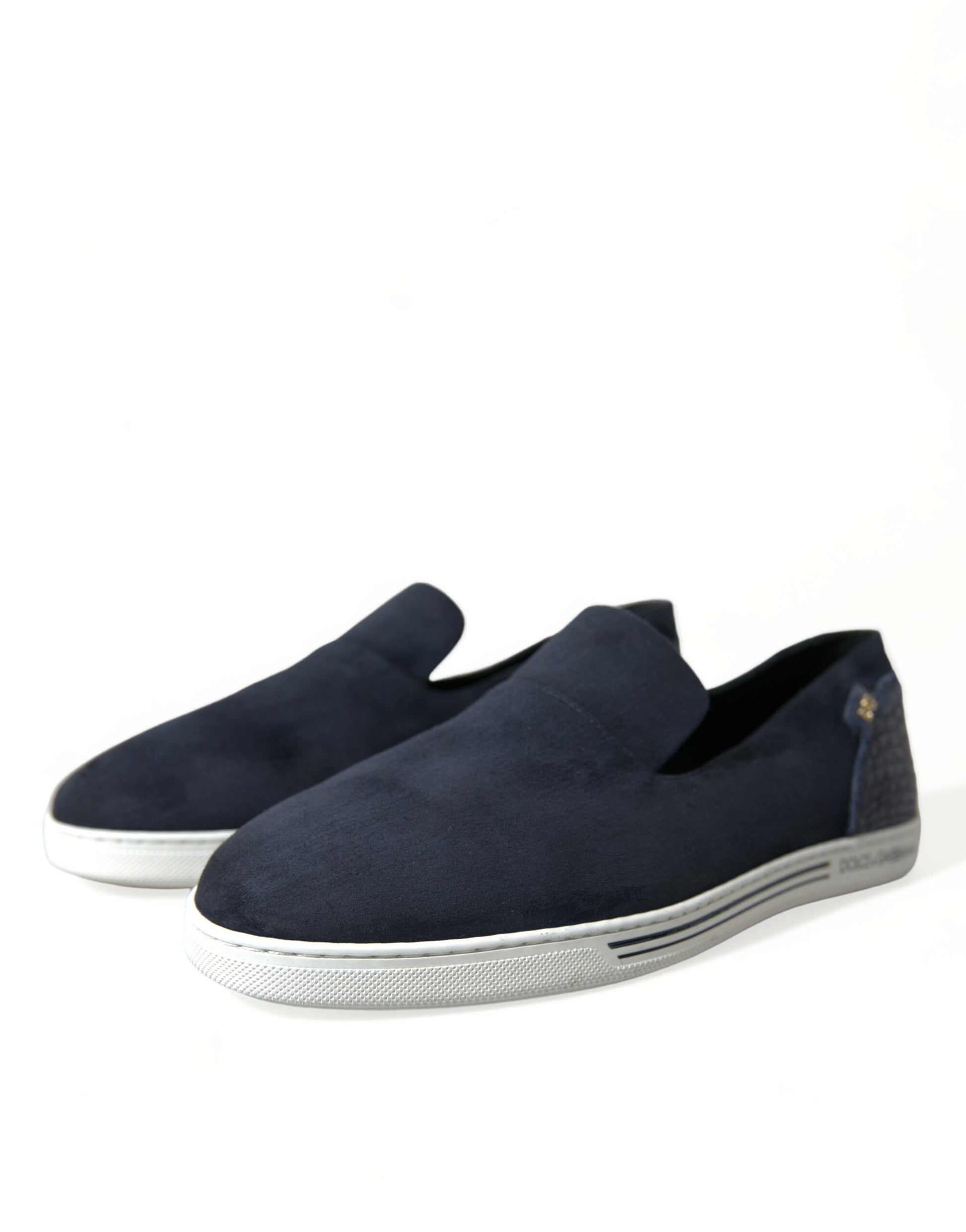 Pair of dark blue suede loafers with white soles and laces