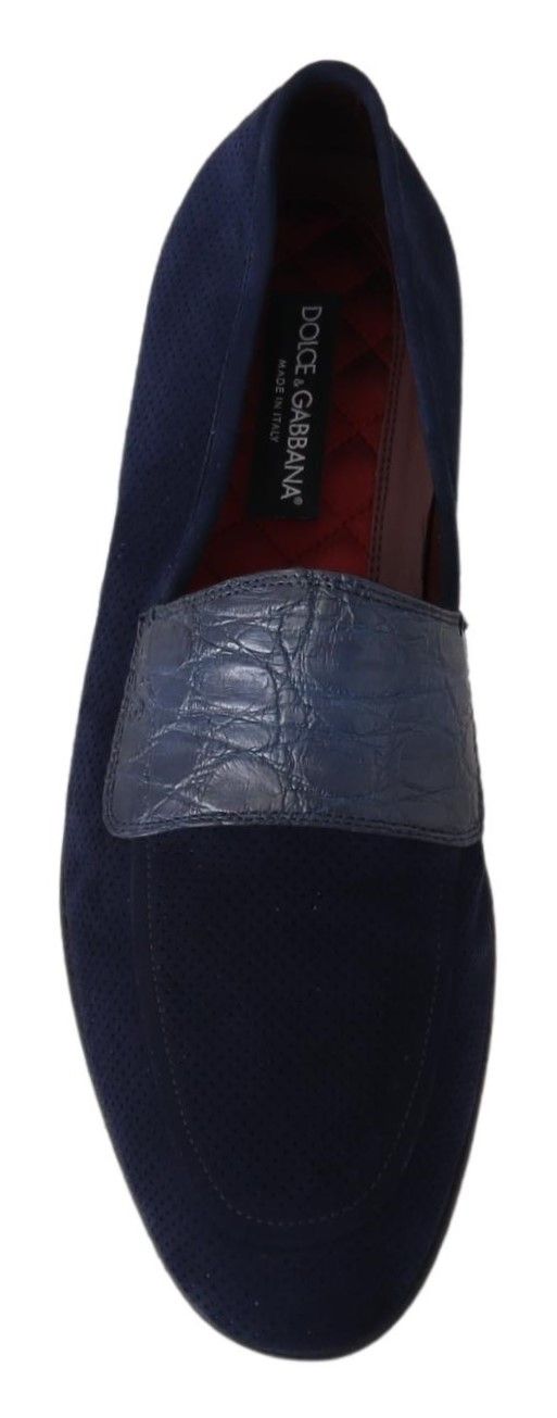 Blue suede loafer shoe with a striped pattern on the side and a silver buckle