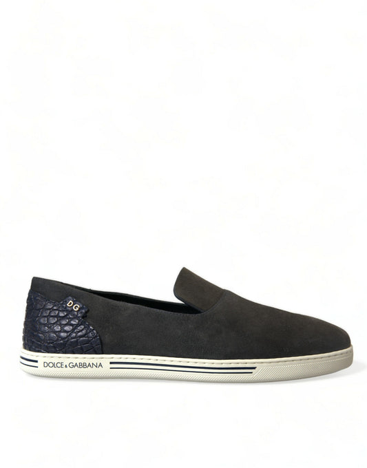 A single shoe against a white background. It is a slip-on style with a dark blue upper and a light blue sole. There are t