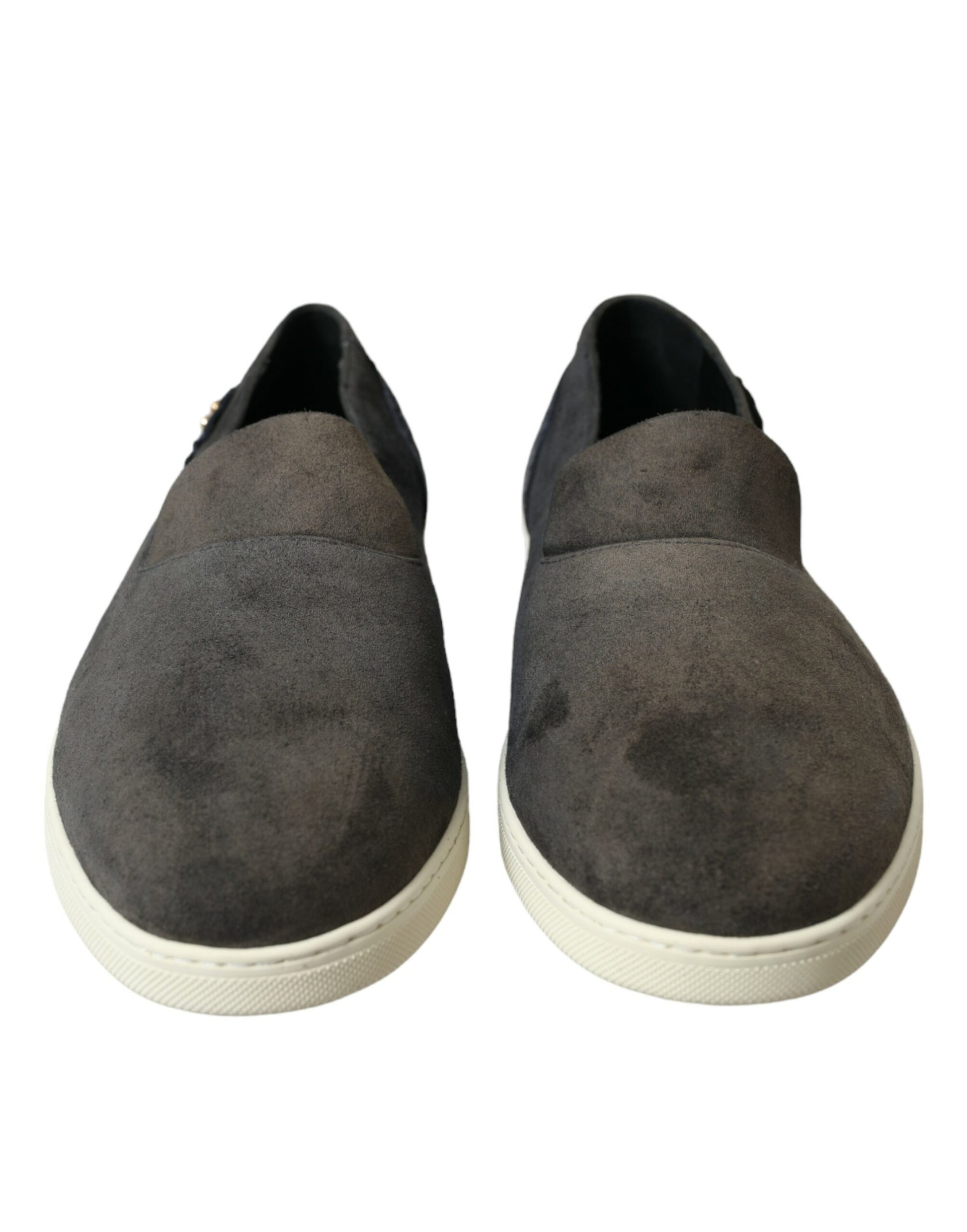 Pair of gray suede loafers with white soles and laces