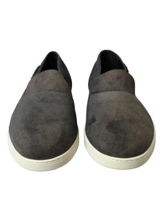 Pair of gray suede loafers with white soles and laces