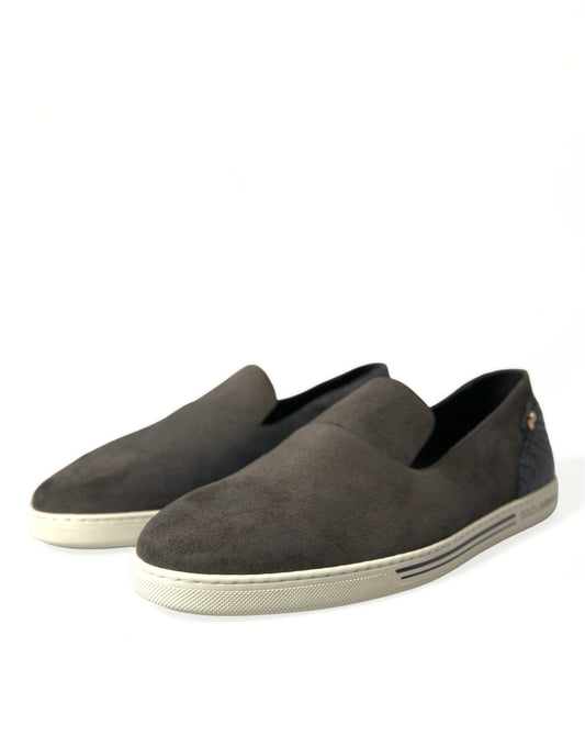 Pair of brown suede loafers with white soles and laces