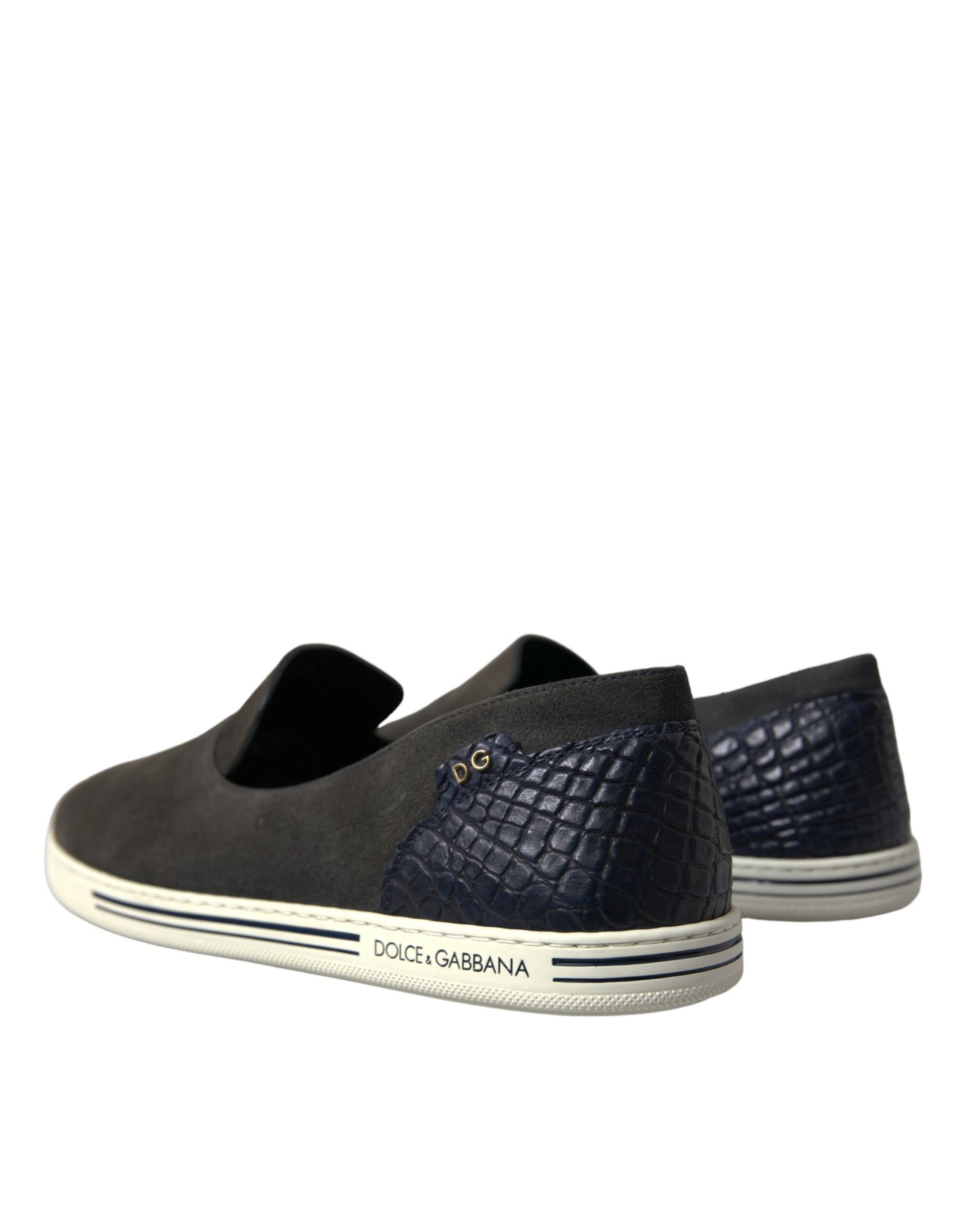 Pair of sneakers with a crocodile skin texture on the side and a logo on the tongue
