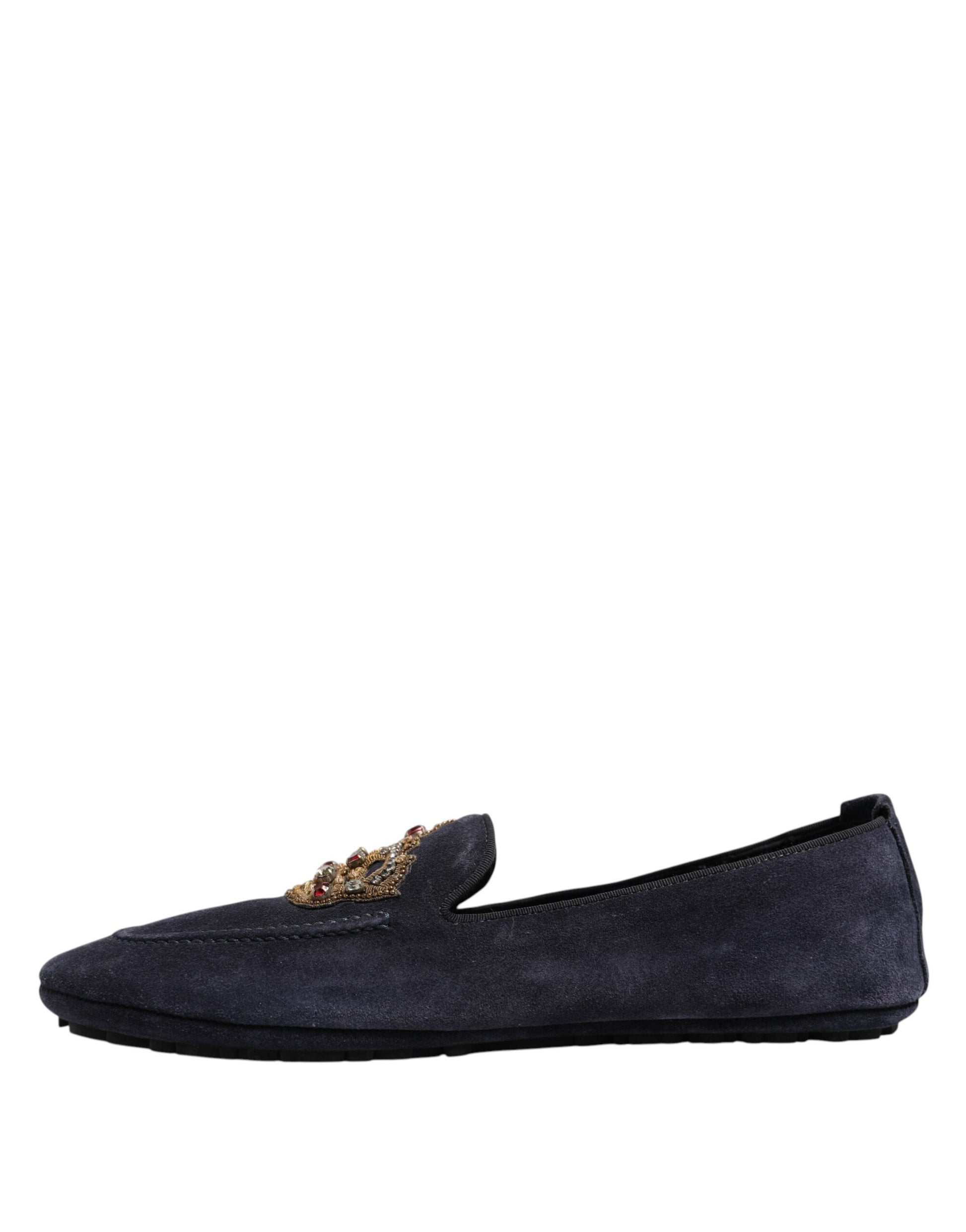 A pair of blue suede loafers with crystal embellishments on the toe