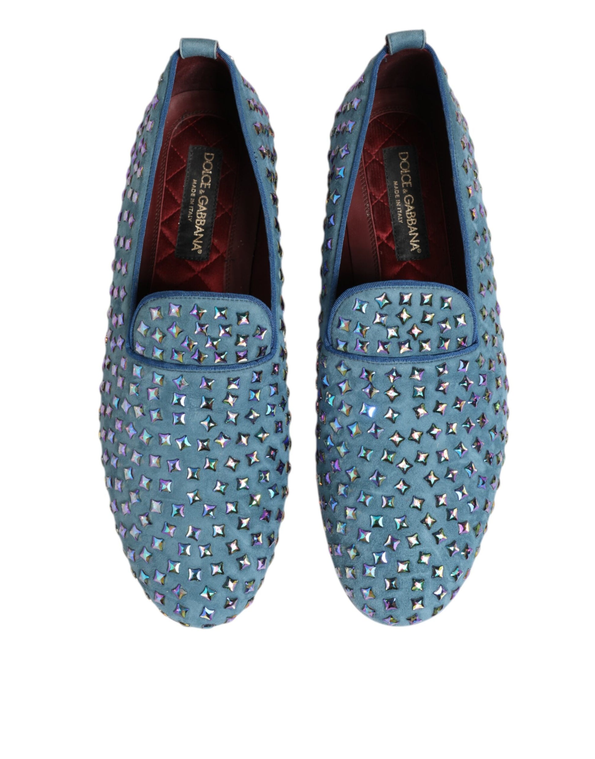 Pair of blue suede loafers with studded detailing, featuring a red interior and a brand logo