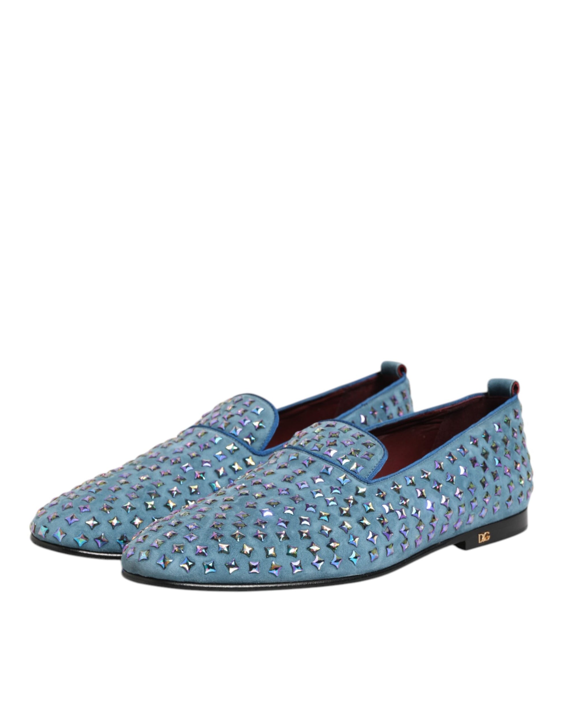 A pair of blue suede loafers with studs, featuring a round toe and elastic panels for comfort