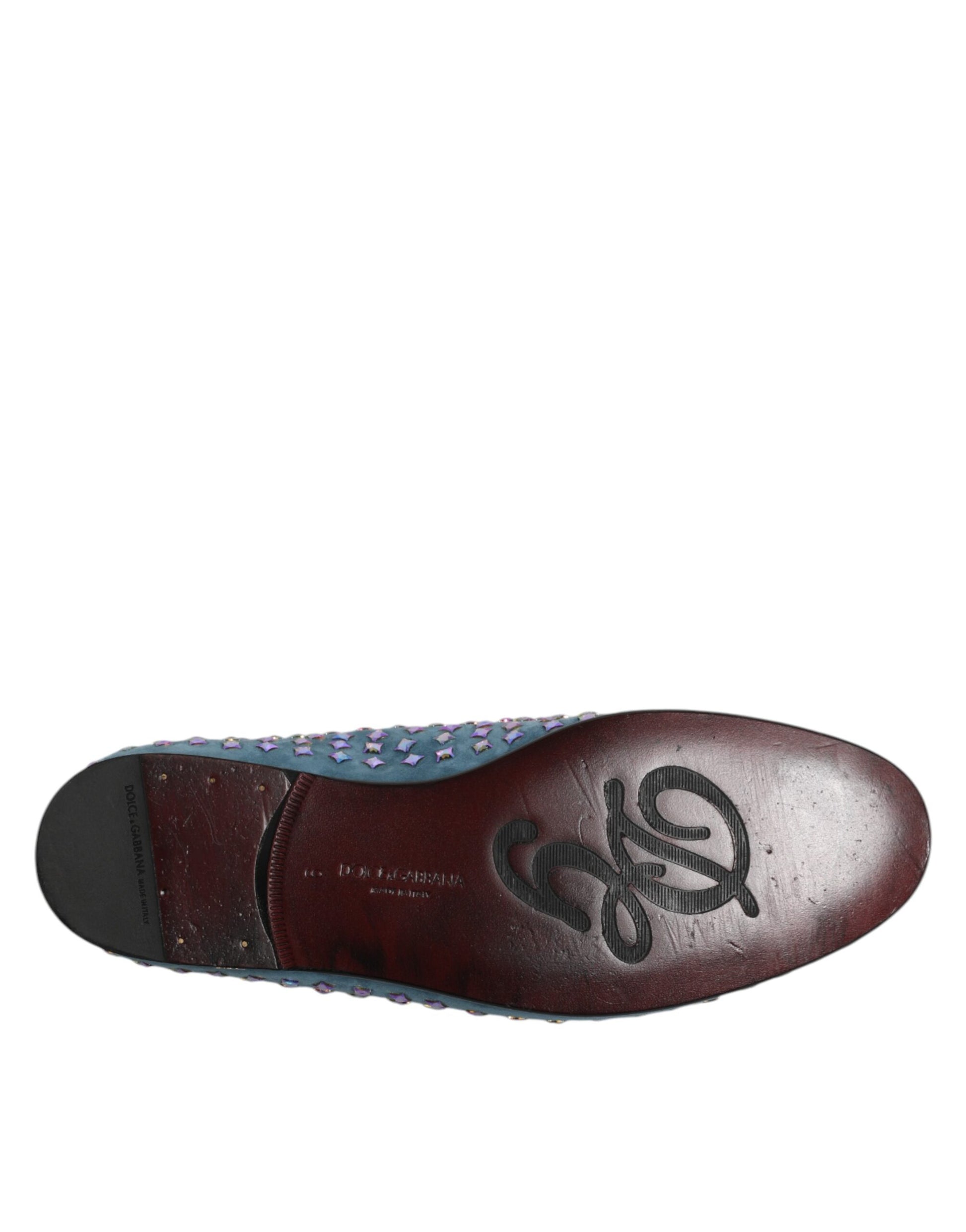 A single brown loafer shoe with blue accents and a studded design on the toe
