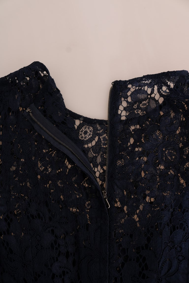 A black lace sheath dress with a floral pattern and zipper detail on the front