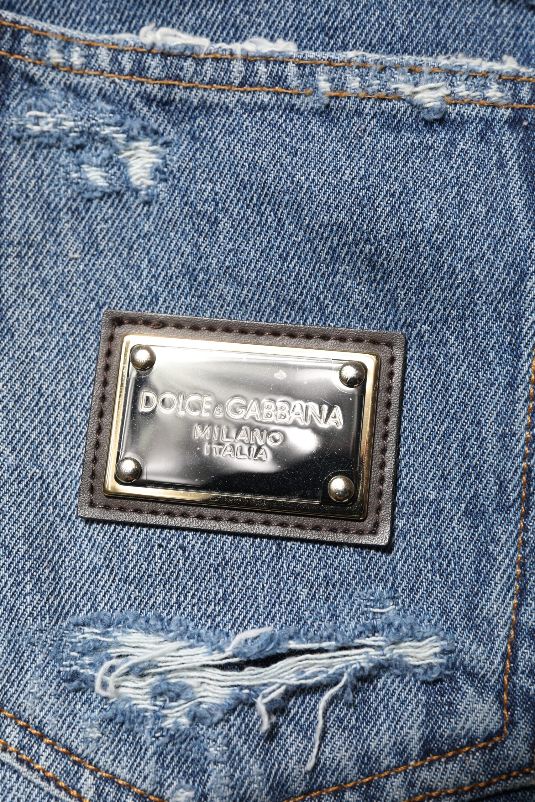 Blue denim jeans with metal brand label