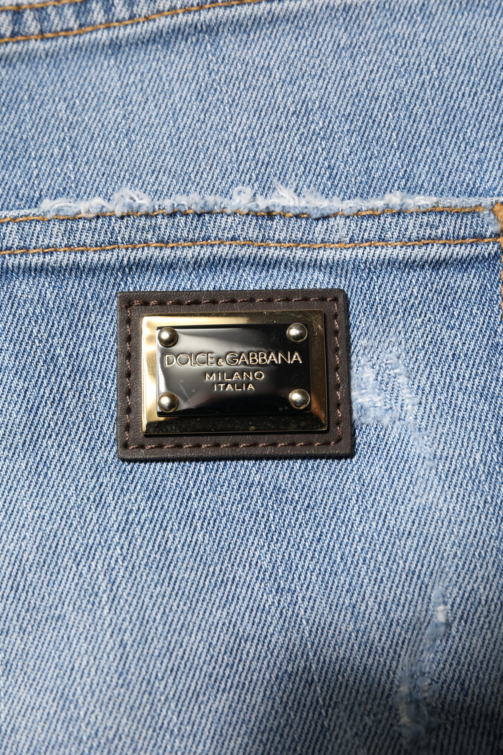 Blue jeans with a gold buckle on the waistband
