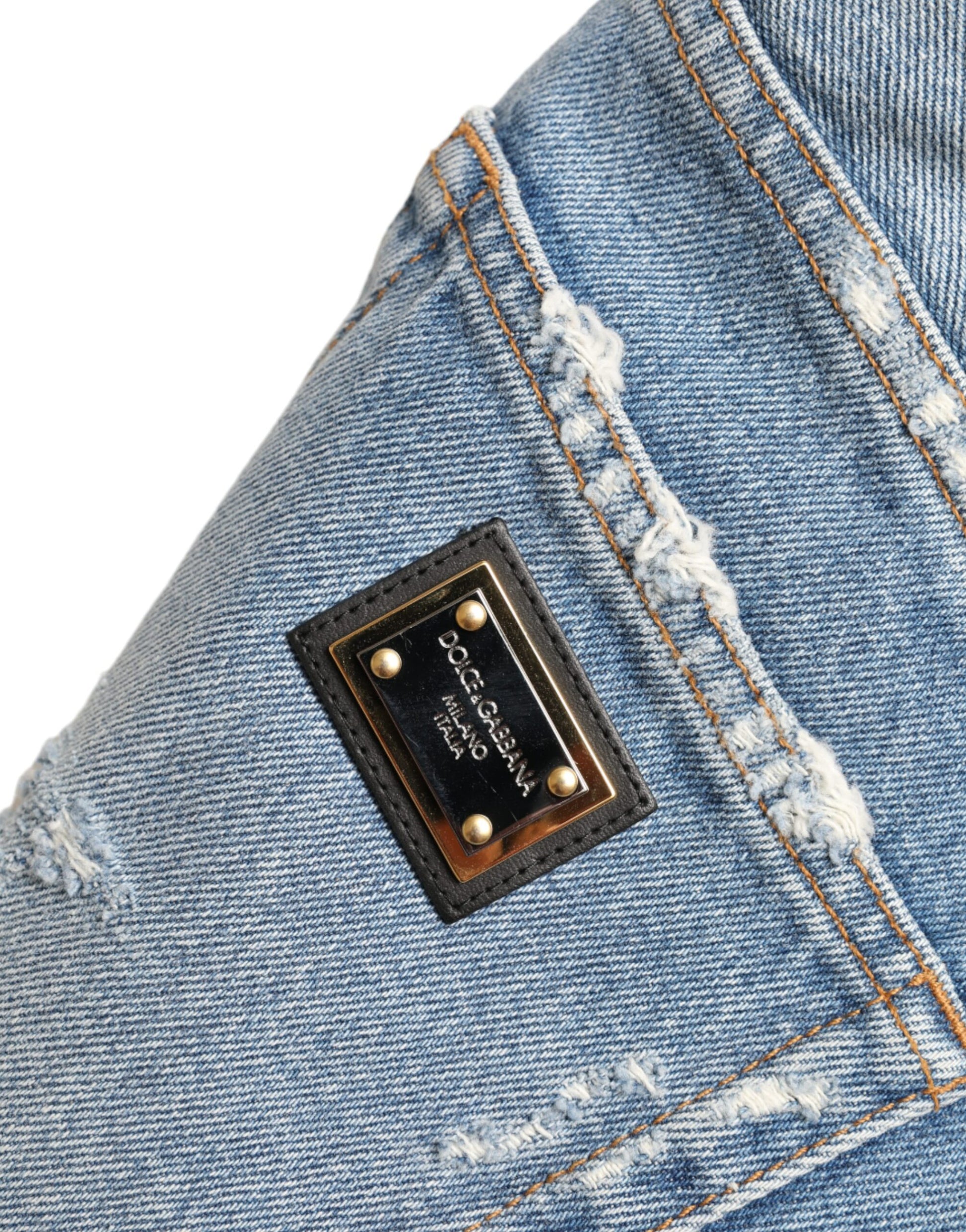 Blue jeans with a black label on the right leg