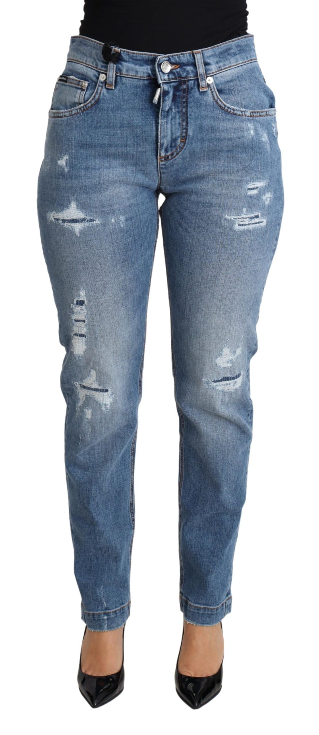 Pair of blue denim jeans with distressed areas on legs