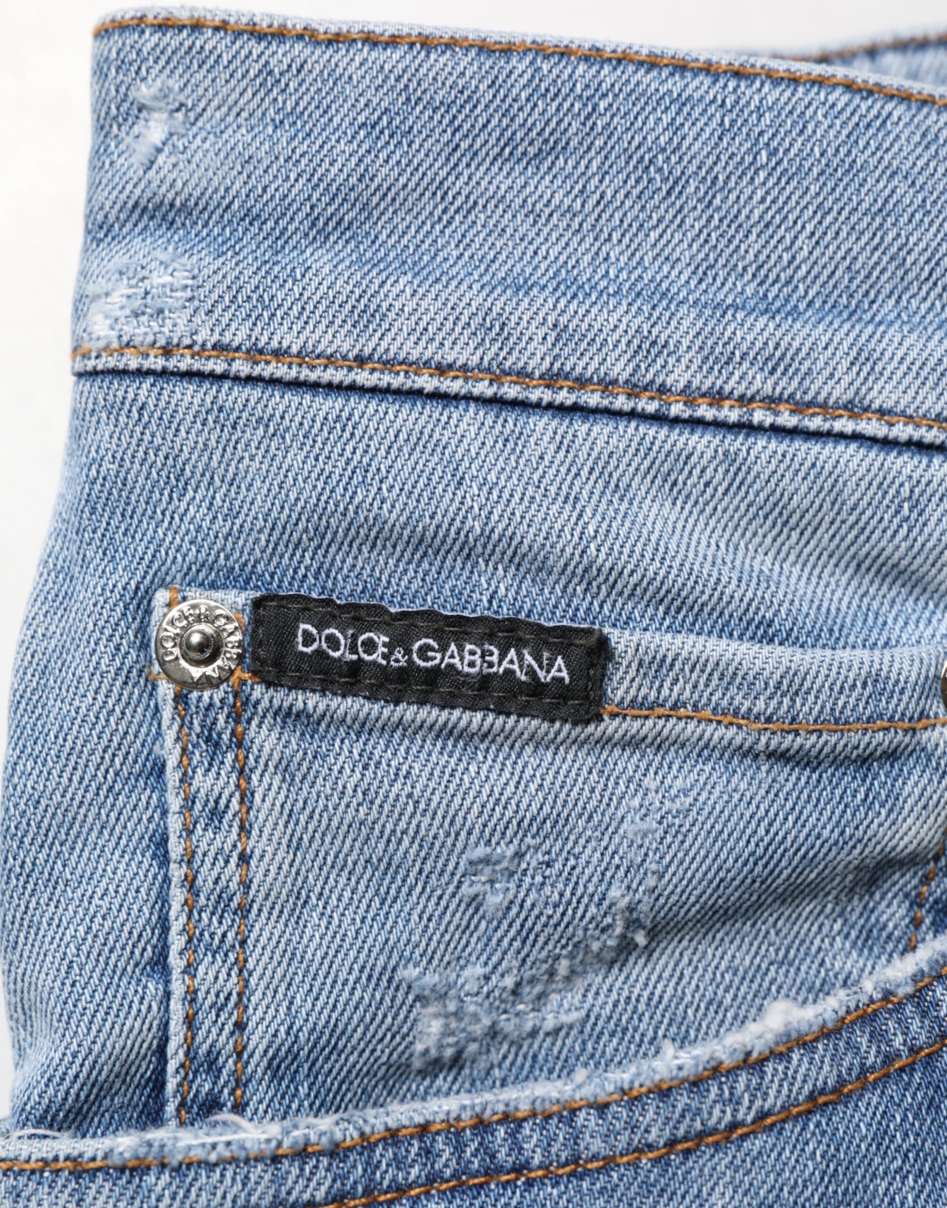 Blue denim jeans with a brand label on the waistband