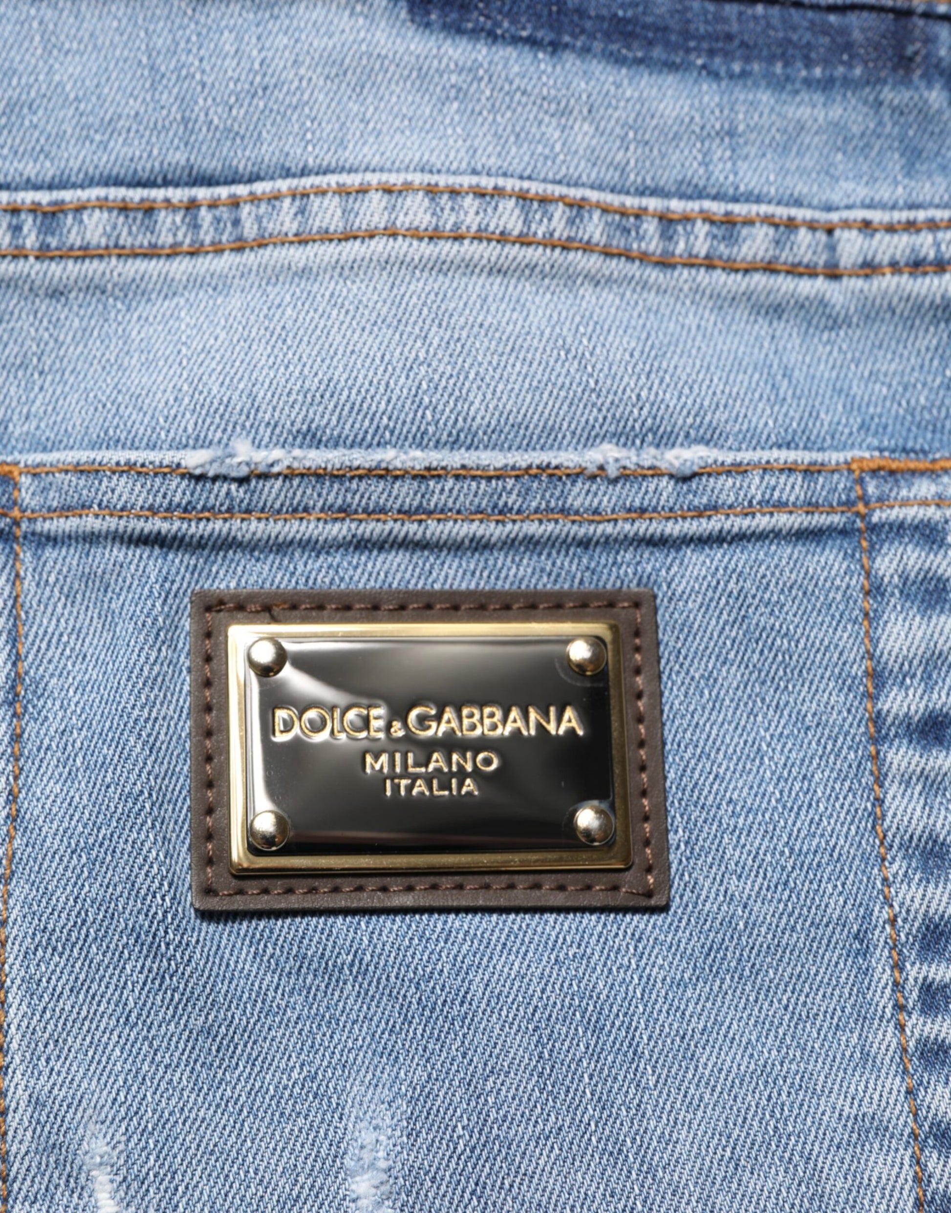 Blue jeans with a gold brand logo on the back pocket