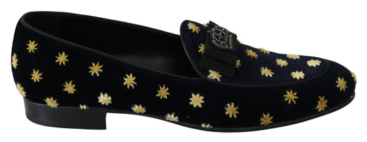 Pair of black velvet loafers with gold star pattern and bow detail