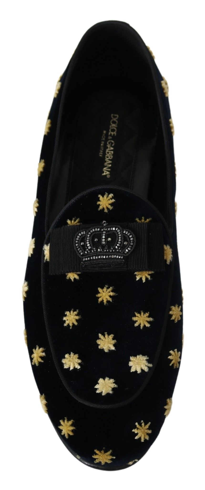 Pair of black velvet slippers with gold star pattern on soles