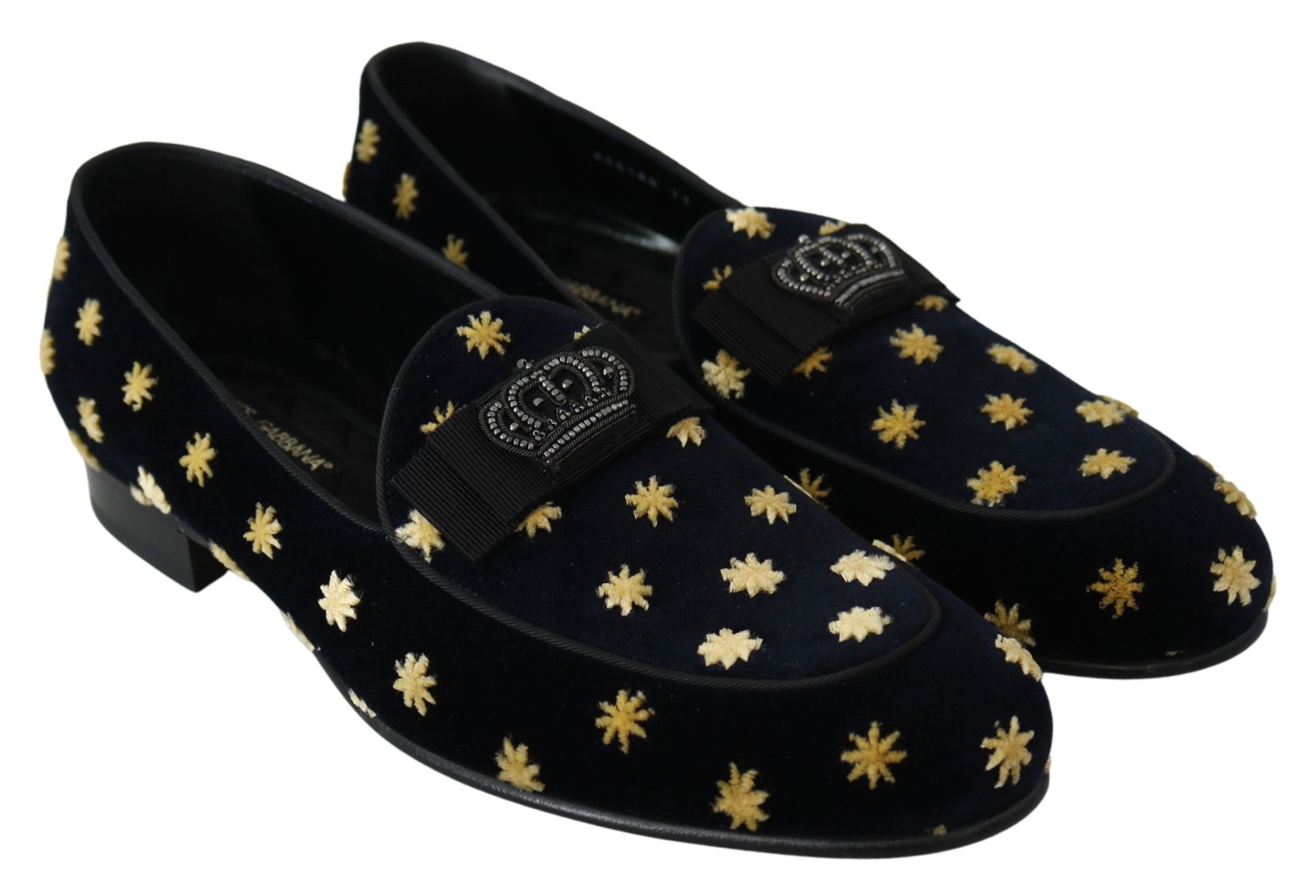 Pair of black velvet shoes with gold star pattern on soles