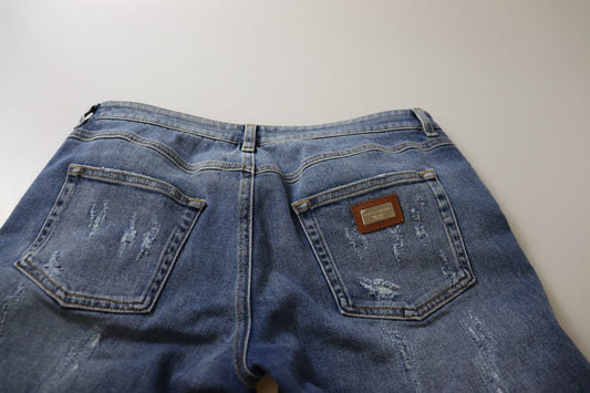 Pair of blue denim jeans with front pockets and a brown leather patch on the right side