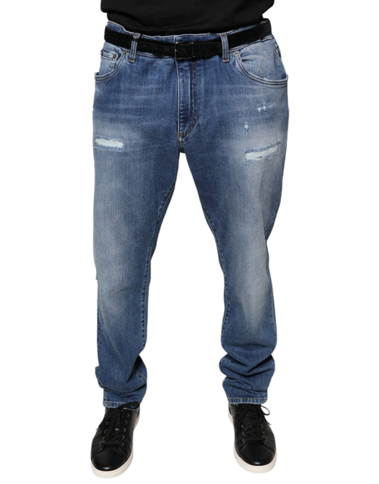 Pair of blue jeans with distressed areas on legs