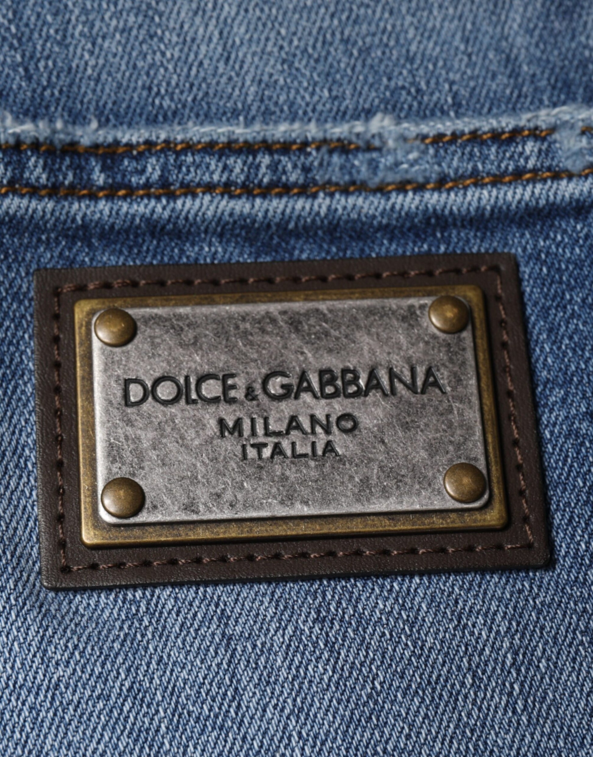 The tag is brown leather with gold lettering