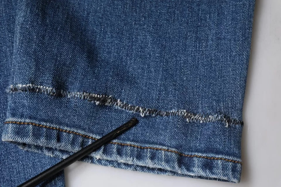 Denim jeans with patched knee holes