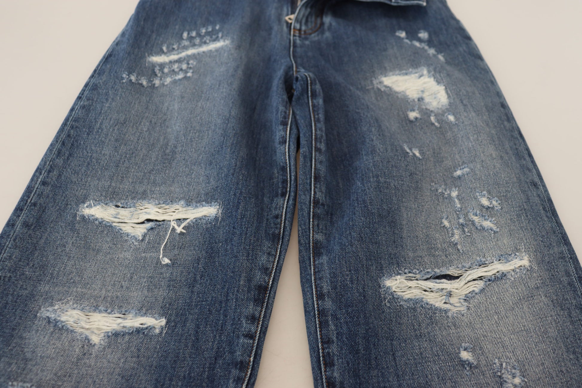 Pair of distressed blue jeans with holes and frayed edges