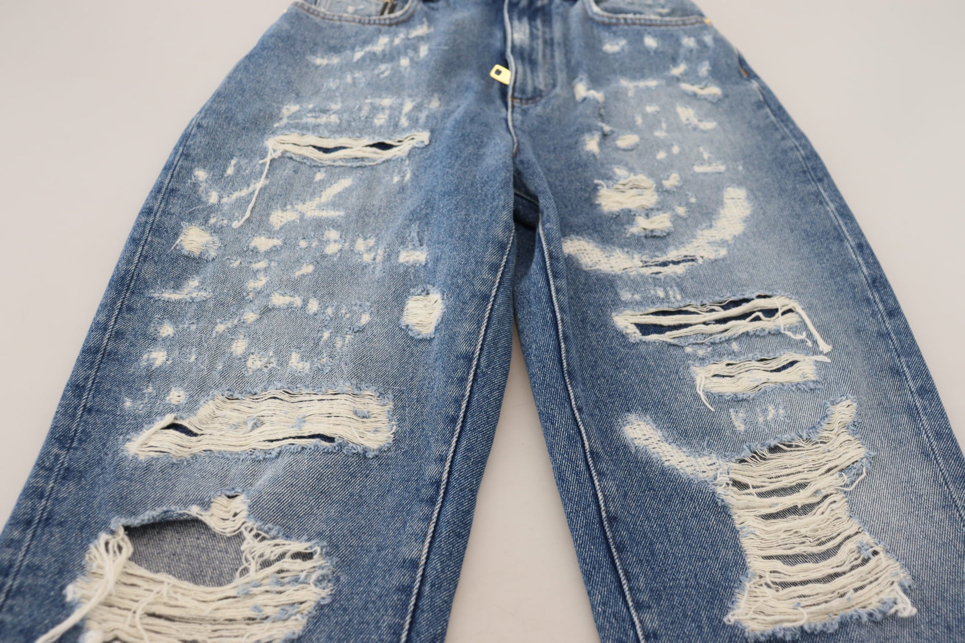 Pair of distressed blue jeans with holes and frayed edges