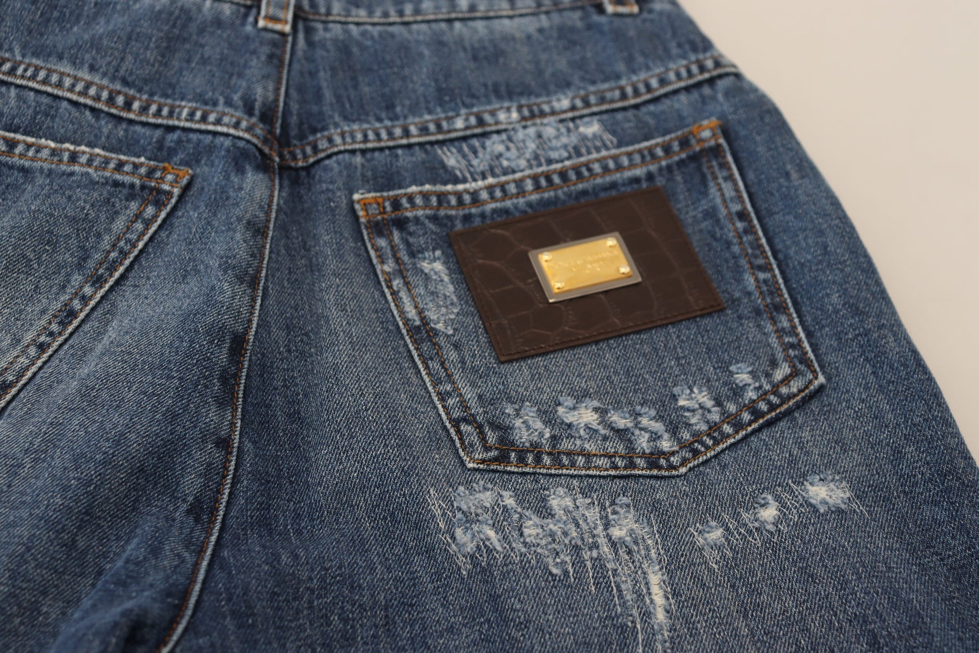 Blue denim jeans with brown leather patch on back pocket