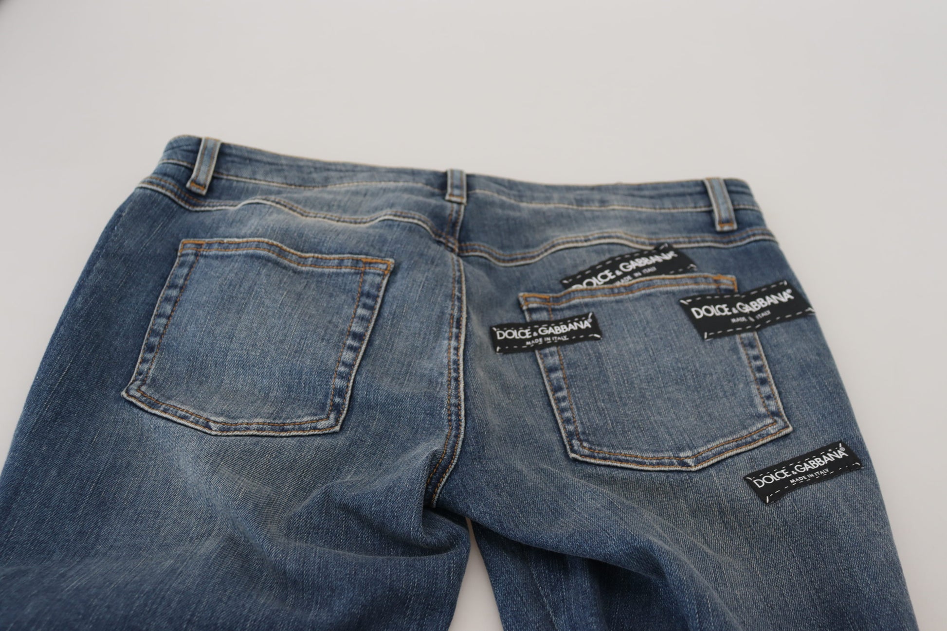 Blue denim jeans with patches on back pockets