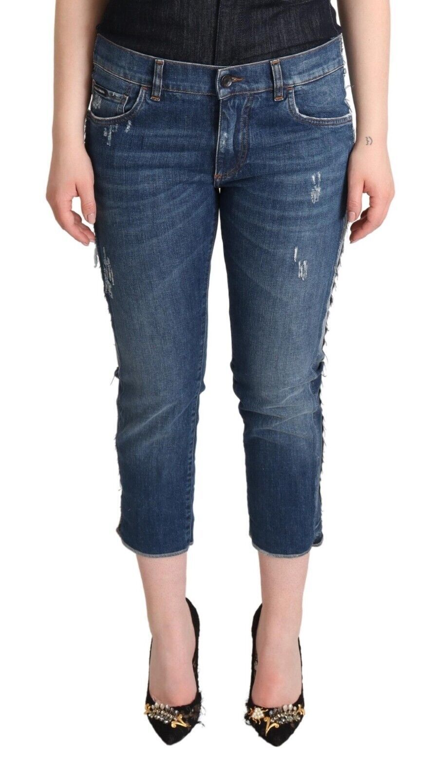 Pair of blue denim jeans with rolled up legs
