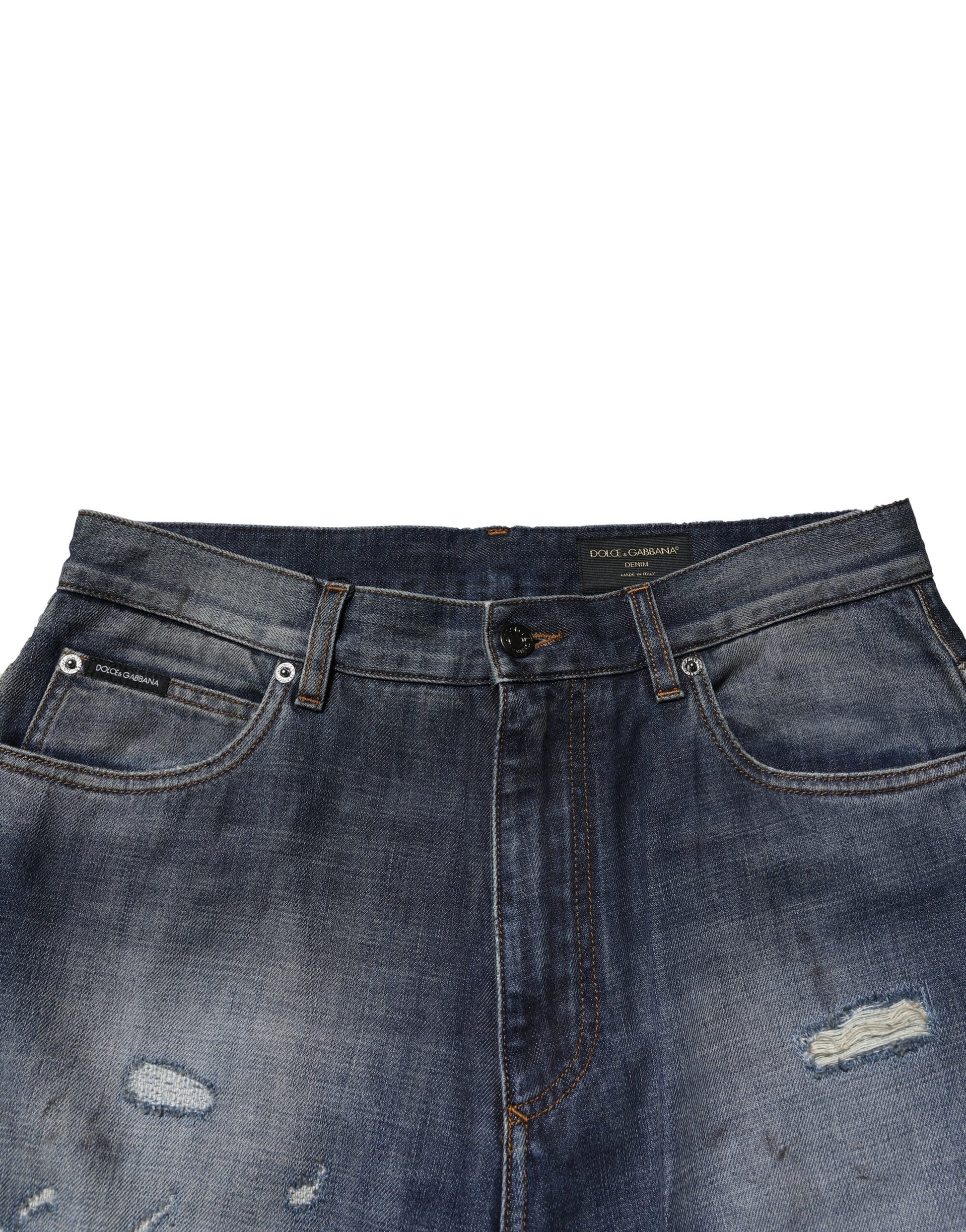 Blue denim jeans with distressed areas on thighs