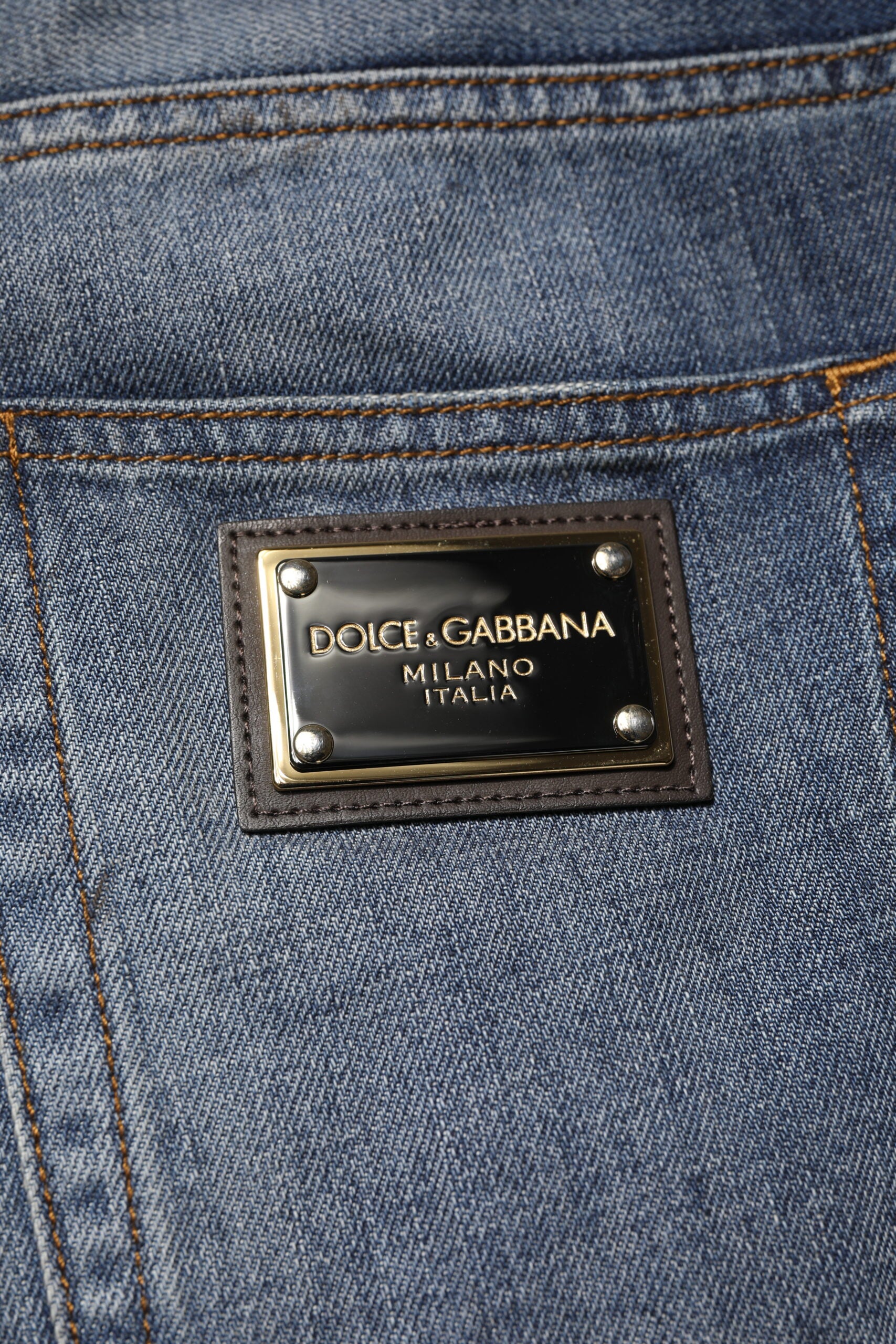 Blue denim jeans with a gold label on the waistband