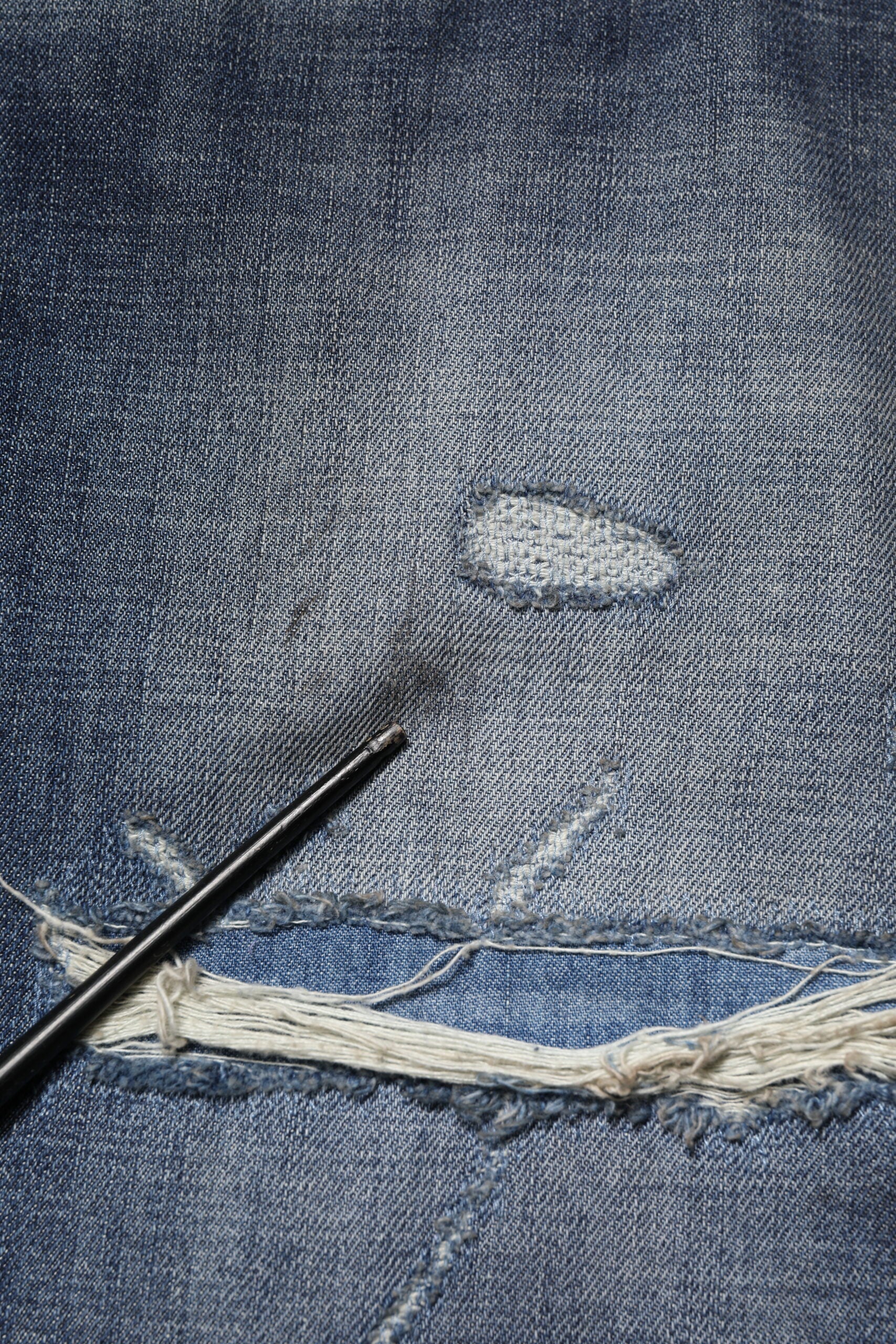 Denim jeans with a patched hole