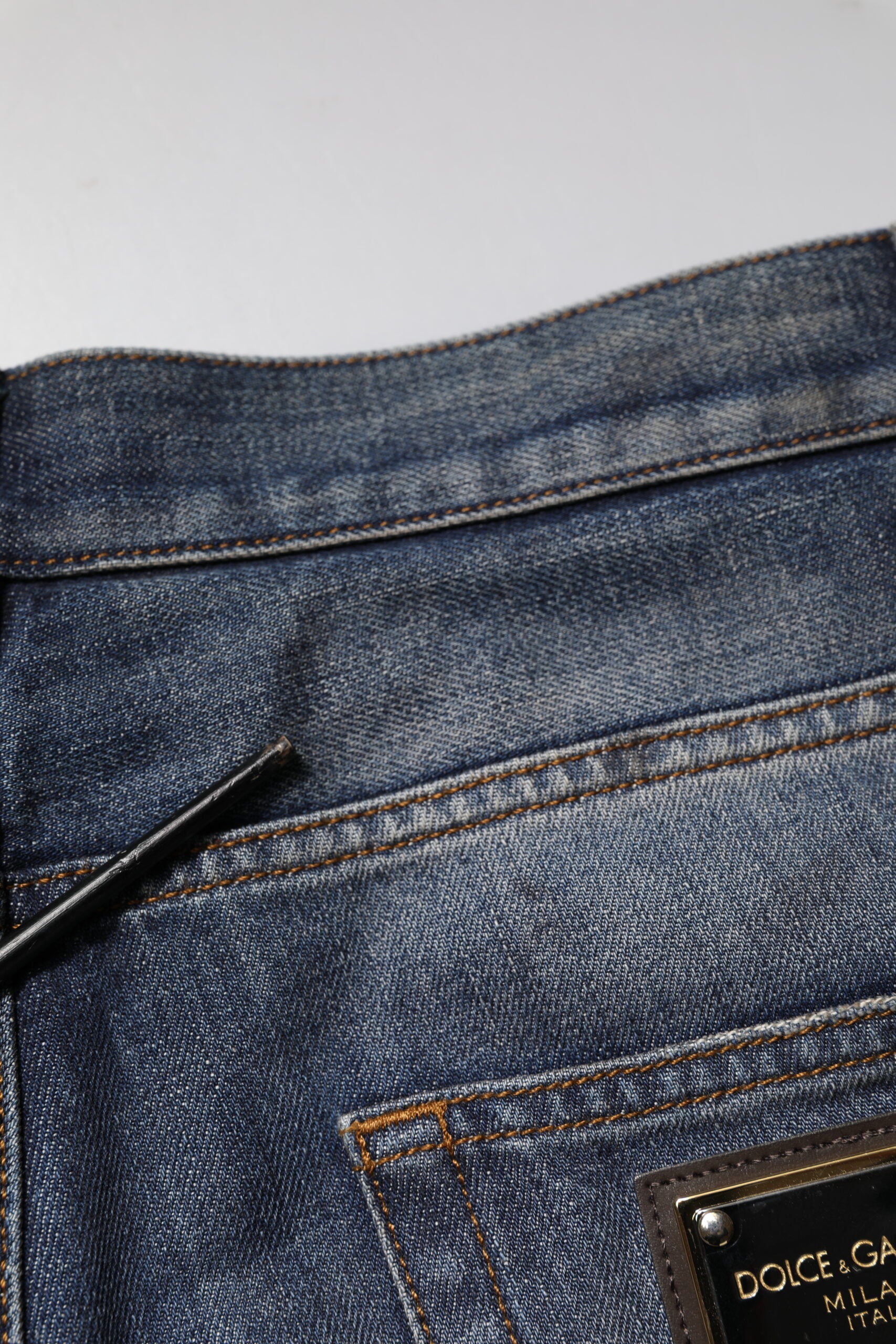 Blue denim jeans with a black zipper on the left side