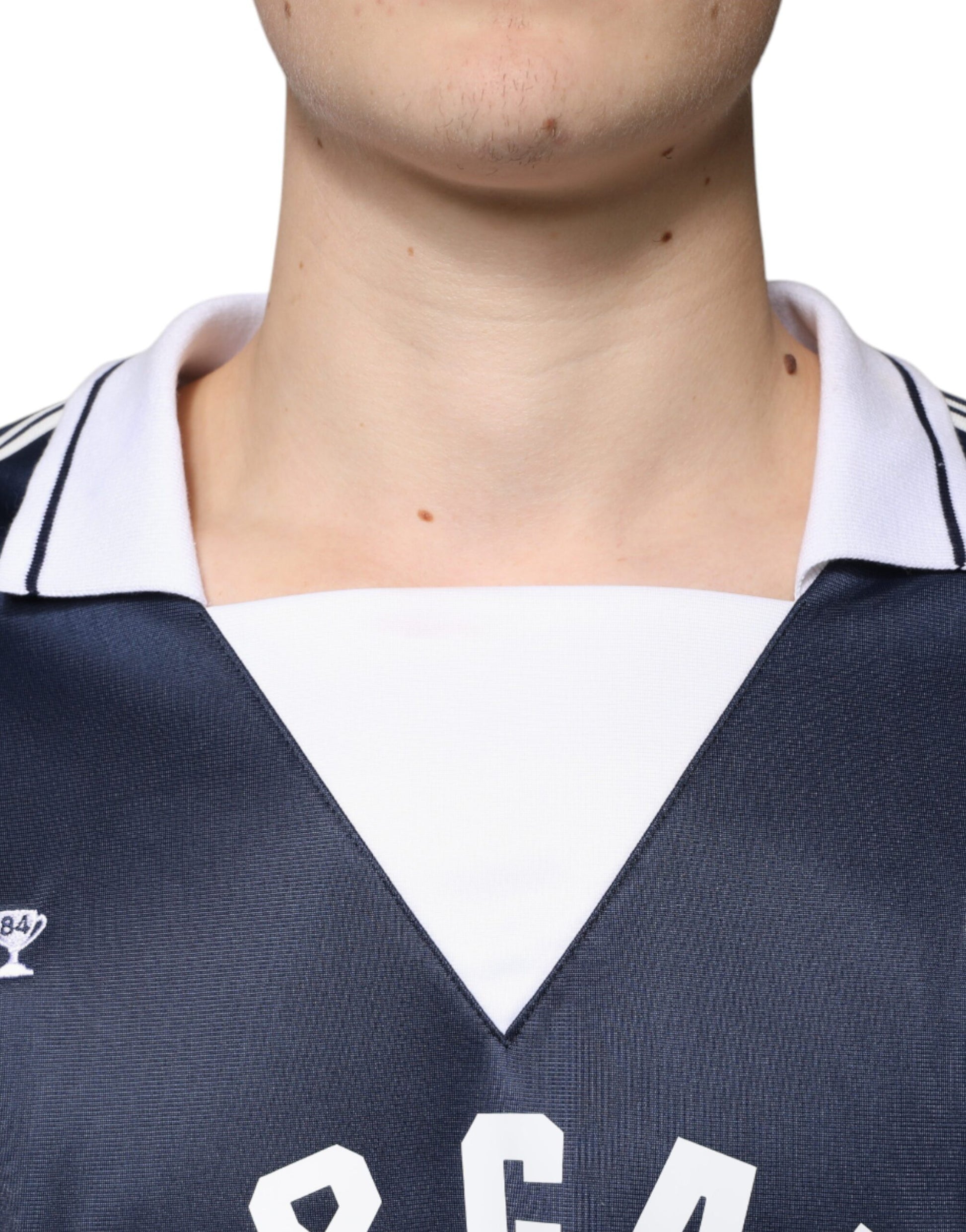 Man wearing blue jersey with white lettering