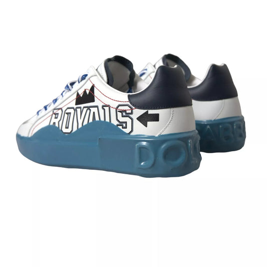 Pair of sneakers with blue soles and white bodies featuring a design that says "ROYALS" in red letters