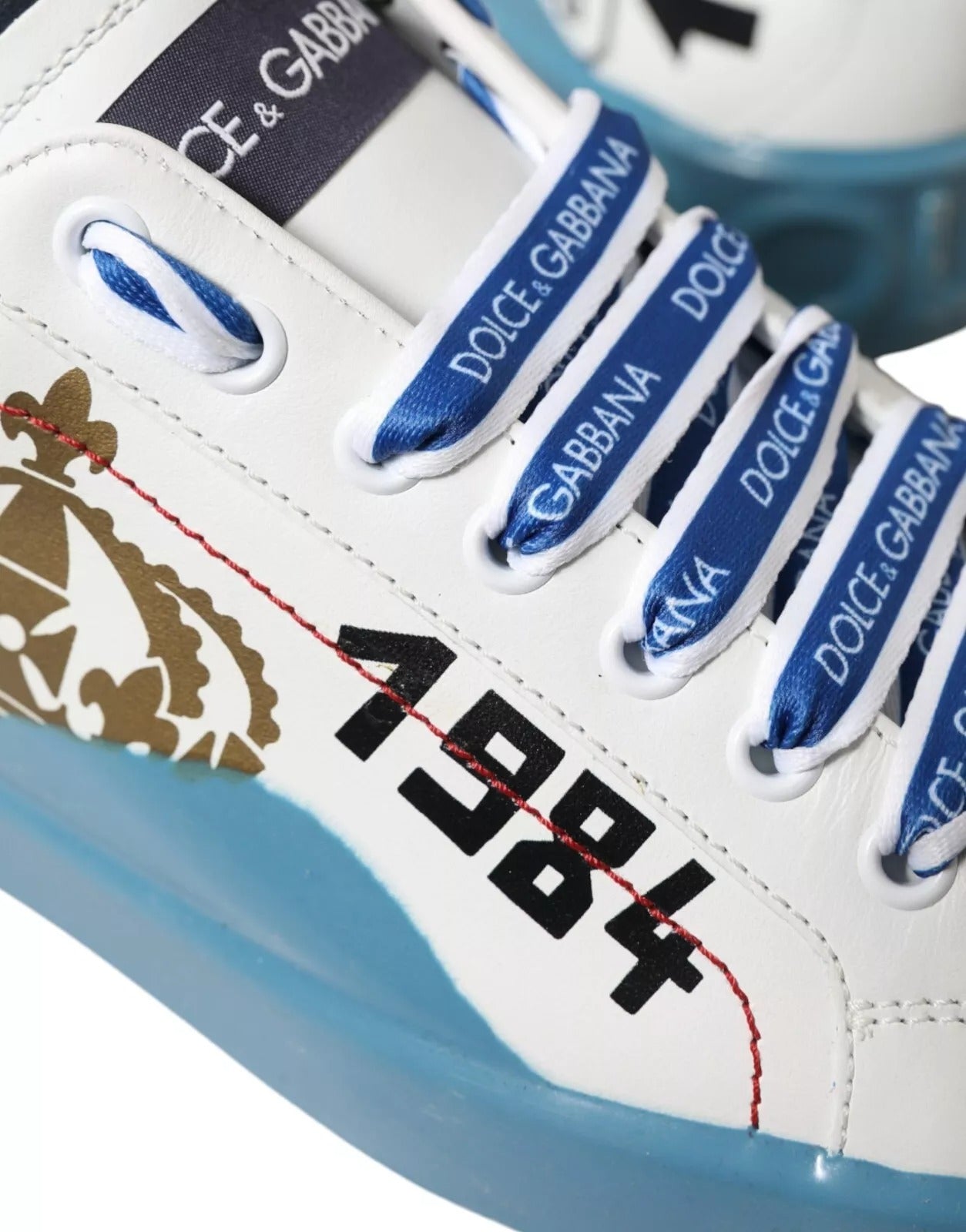 Blue and white sneaker with brand logos on laces