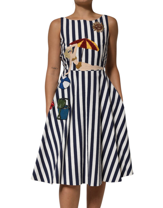 A blue and white striped dress with embroidery on the bodice
