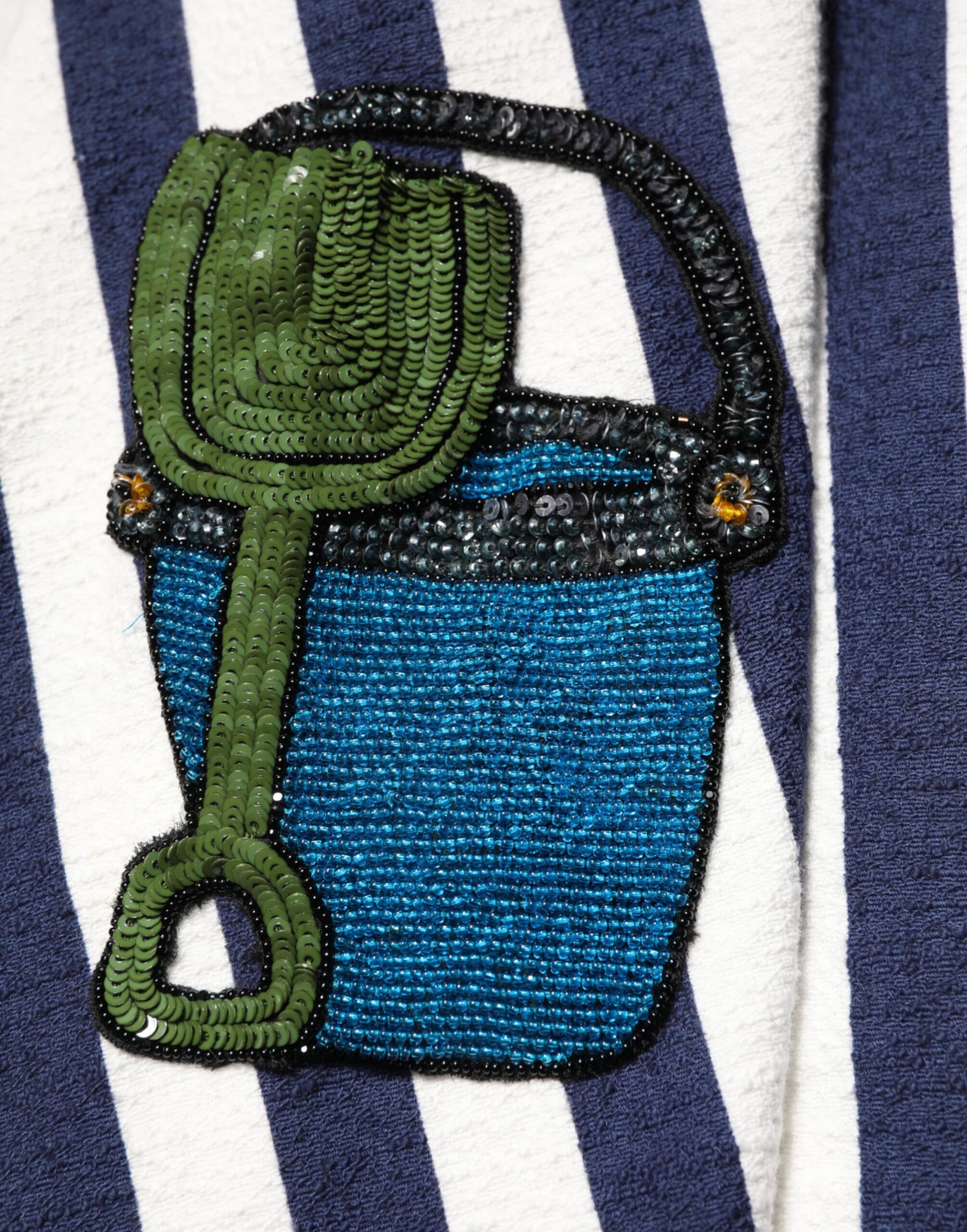 Hand embroidered blue and white striped dress with green watering can design on front