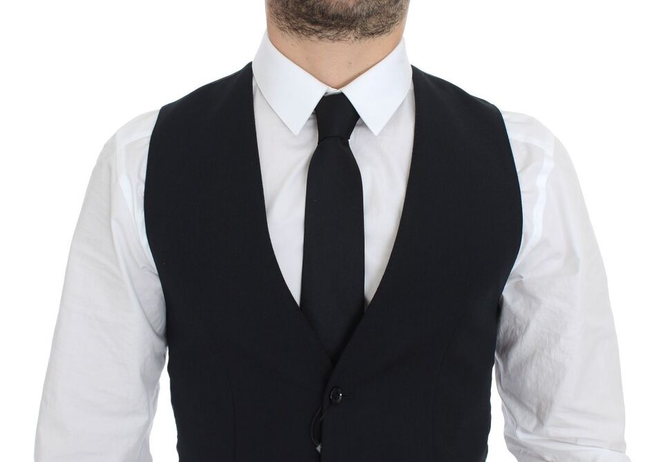 A mannequin wearing a blue wool vest with black tie and white shirt