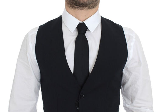 A mannequin wearing a blue wool vest with black tie and white shirt