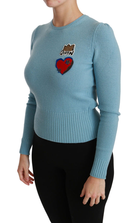 Woman wearing blue sweater with heart design on front