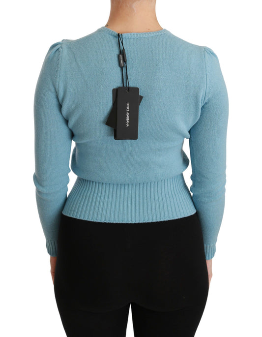 Woman wearing blue sweater with tag on back