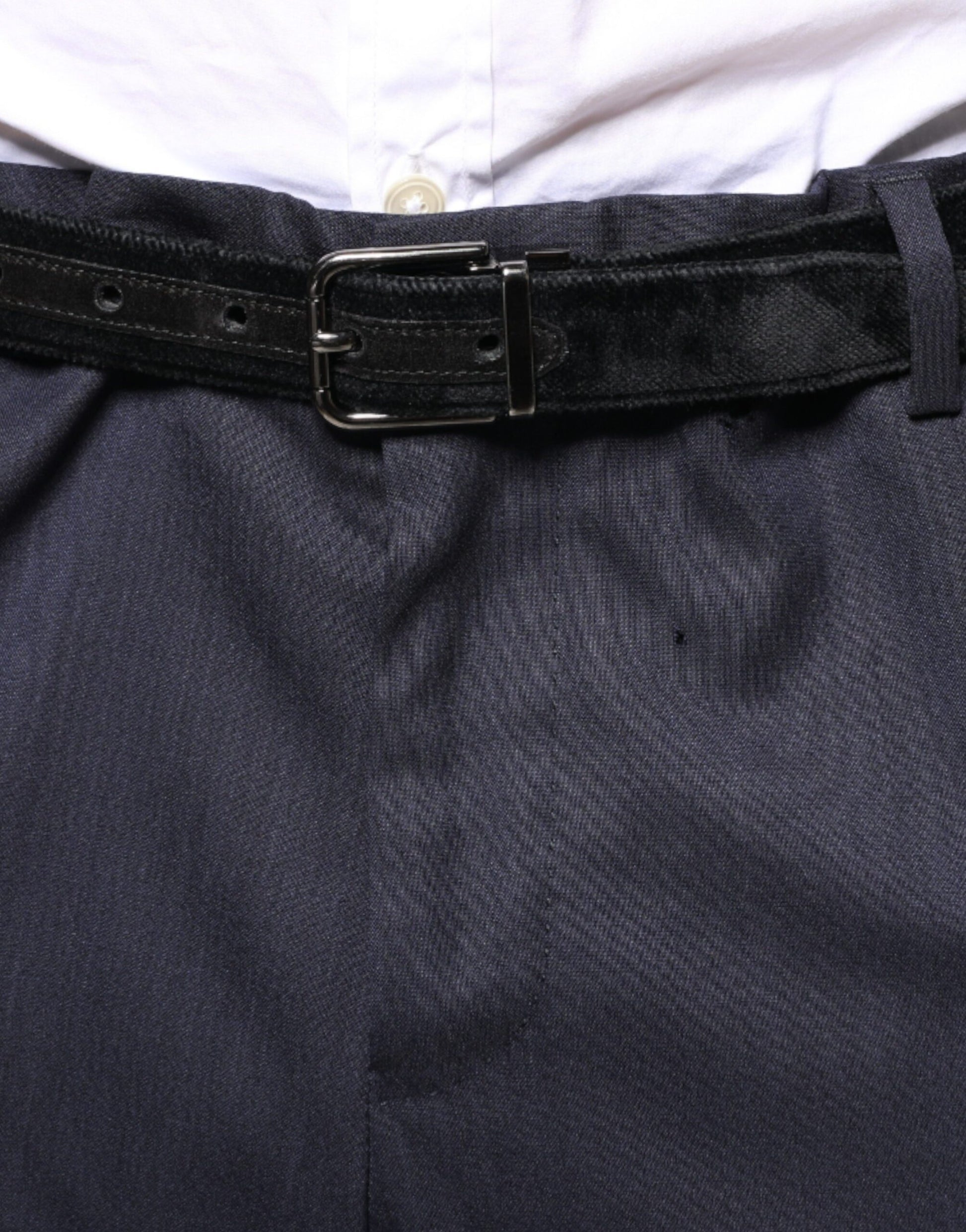 A pair of blue wool skinny formal dress pants with a belt loop and black belt