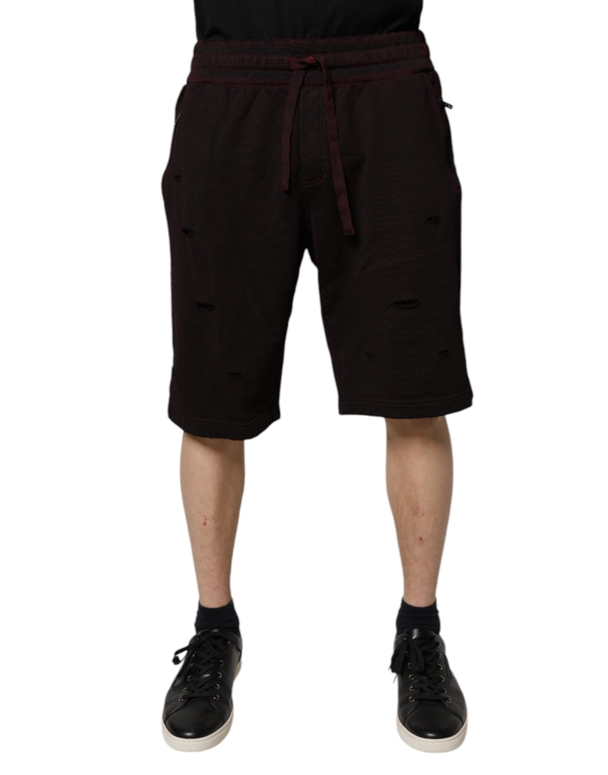 A pair of black shorts with a drawstring waist. They appear to be made of cotton and have a bermuda style, wh